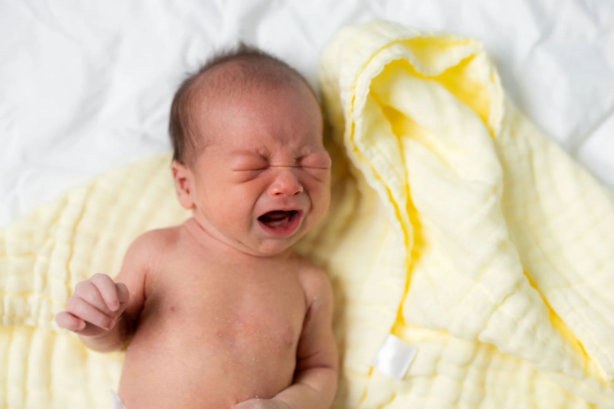 New,Born,Baby,Cry,On,Bed